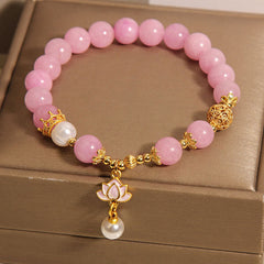 Pink Quartzite Pearl Lotus Bracelet - 45-degree view on taupe cushion with filigree gold beads, Feminine