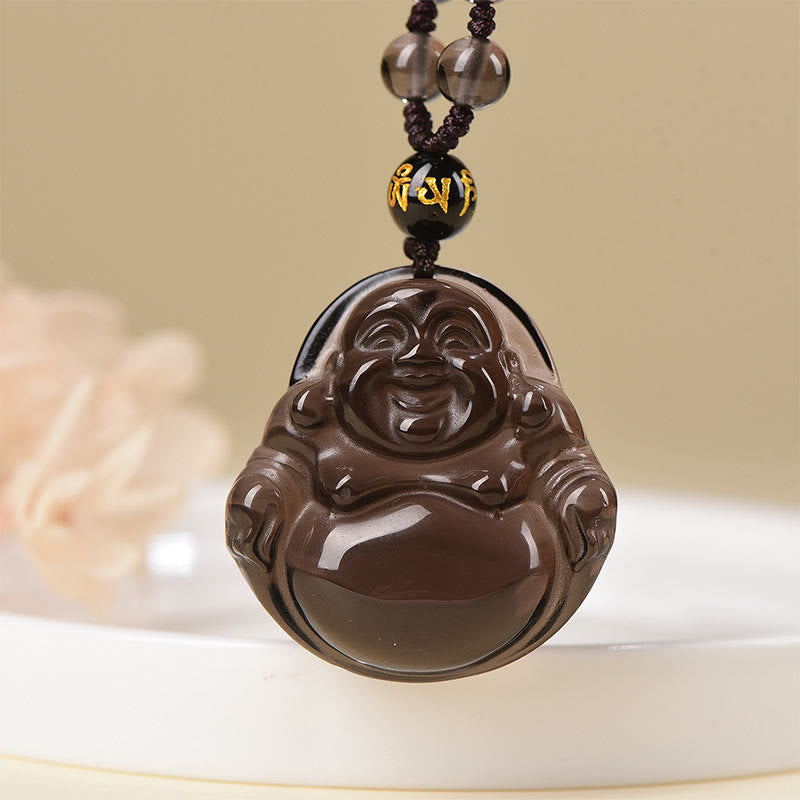 Black Obsidian Buddha Necklace – pendant held to lamp showing ice obsidian transparency, quality test