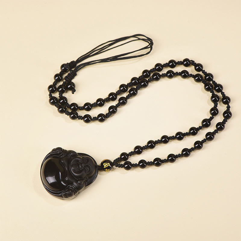 Black Obsidian Buddha Necklace – obsidian texture close-up showing natural glassy fracture lines