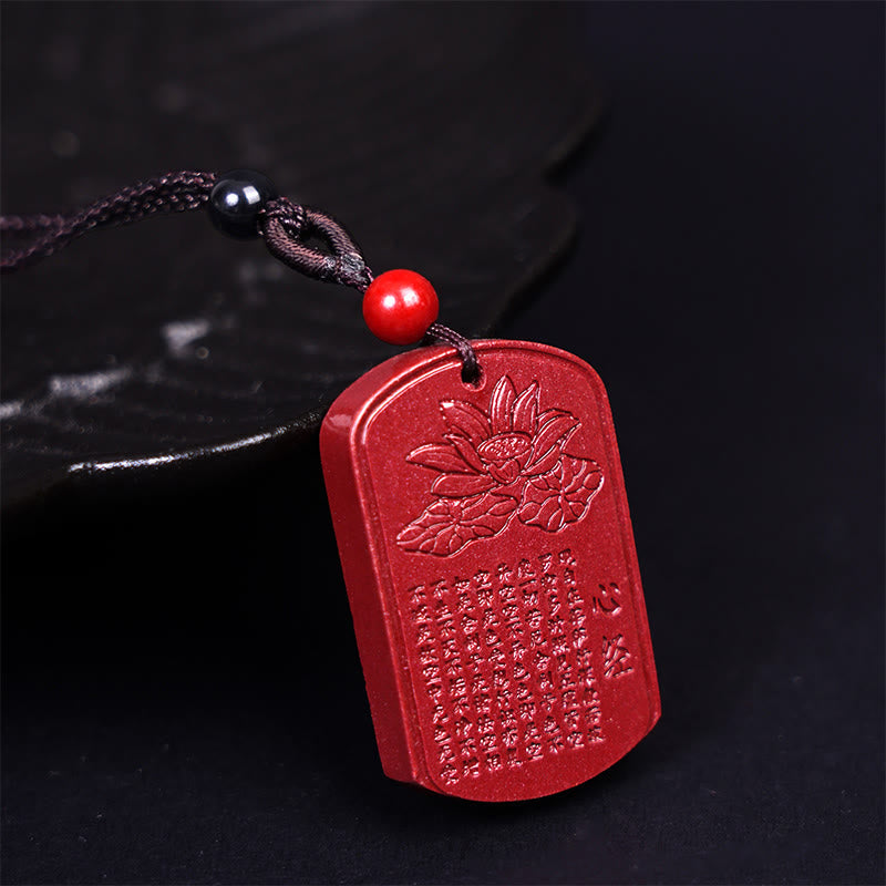 Cinnabar Heart Sutra Pendant – angled view showing lotus carving and sutra text, spiritual necklace
