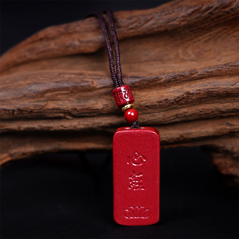 Cinnabar Lotus Pendant – frontal view with carved bead and gold ring spacer on braided cord, Buddhist necklace