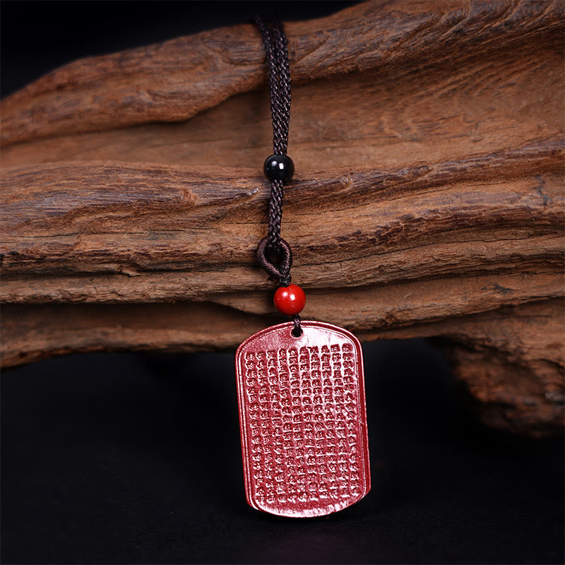Heart Sutra Cinnabar Pendant – close-up of micro-carved Buddhist text on red stone, detailed craftsmanship