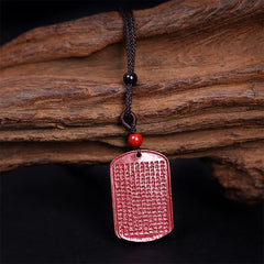 Heart Sutra Cinnabar Pendant – close-up of micro-carved Buddhist text on red stone, detailed craftsmanship