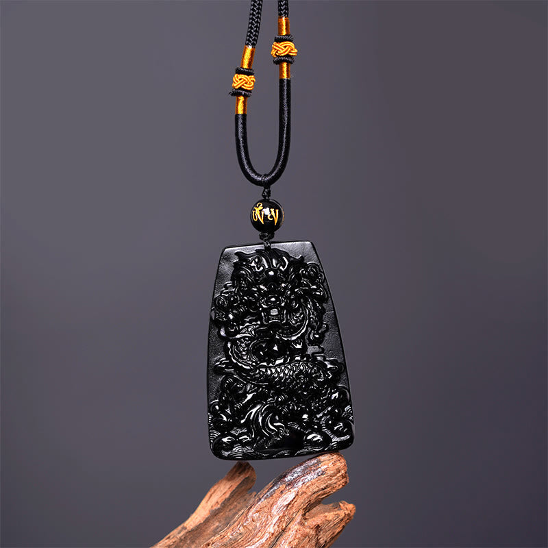 Black Obsidian Dragon Carved Pendant – Frontal view with gold-accented sliding knot cord and mantra bead, amulet
