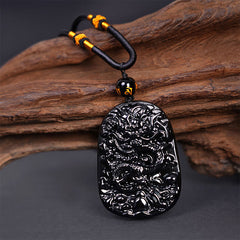 Black Obsidian Dragon Carved Pendant – Three-quarter view of coiled dragon relief with cloud motifs, powerful