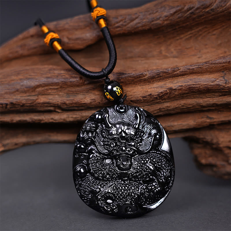 Black Obsidian Round Dragon Pendant – oval carved dragon disc with cord on driftwood, powerful