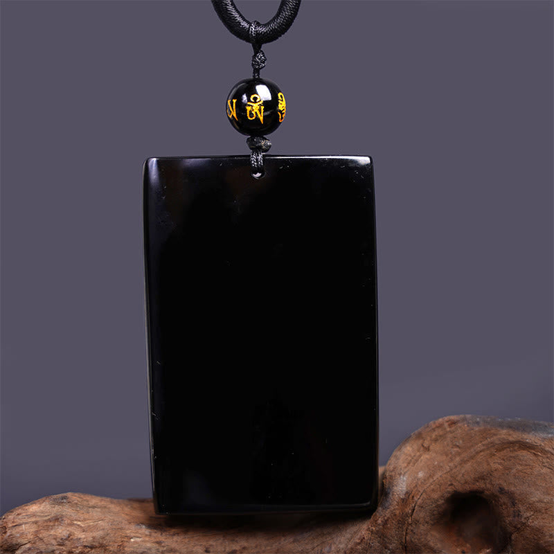 Black Obsidian Dragon Pendant – smooth uncarved rectangular tablet with mantra bead on gray, zen