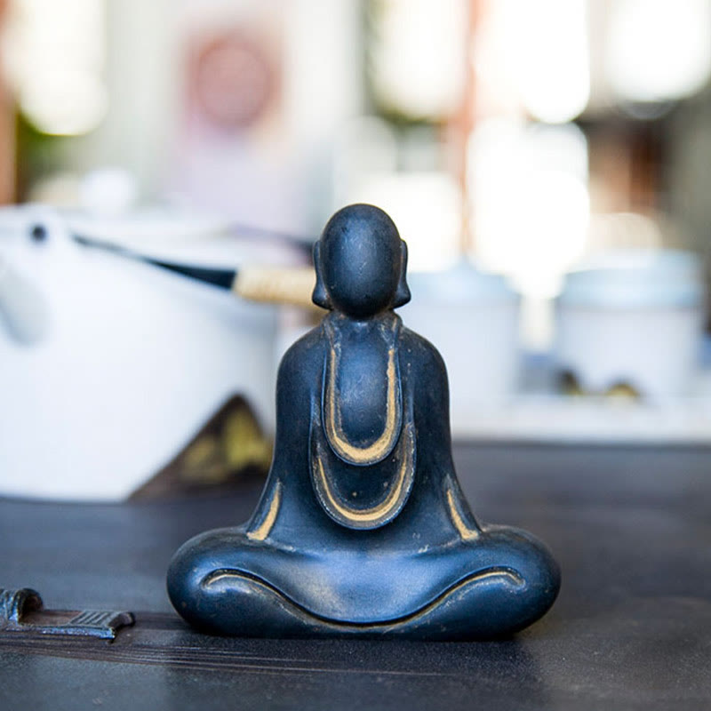 Tibetan Buddha Statue – golden accent light on dark resin, warm glow tibetan buddha display