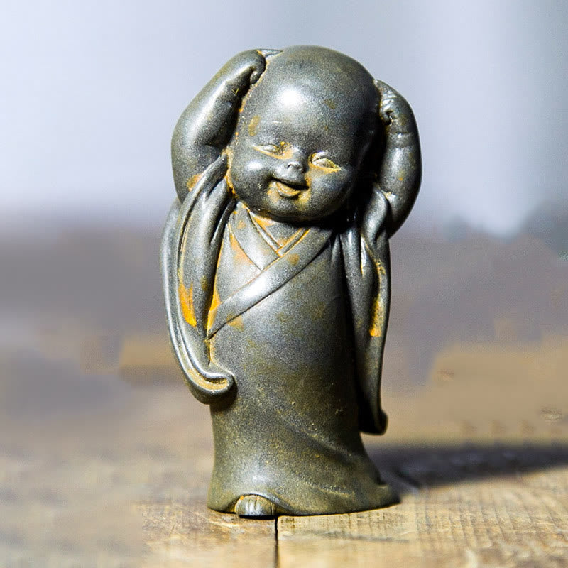 Small Meditating Monk Statue – soft desk lamp light on statue, warm glow monk figurine display