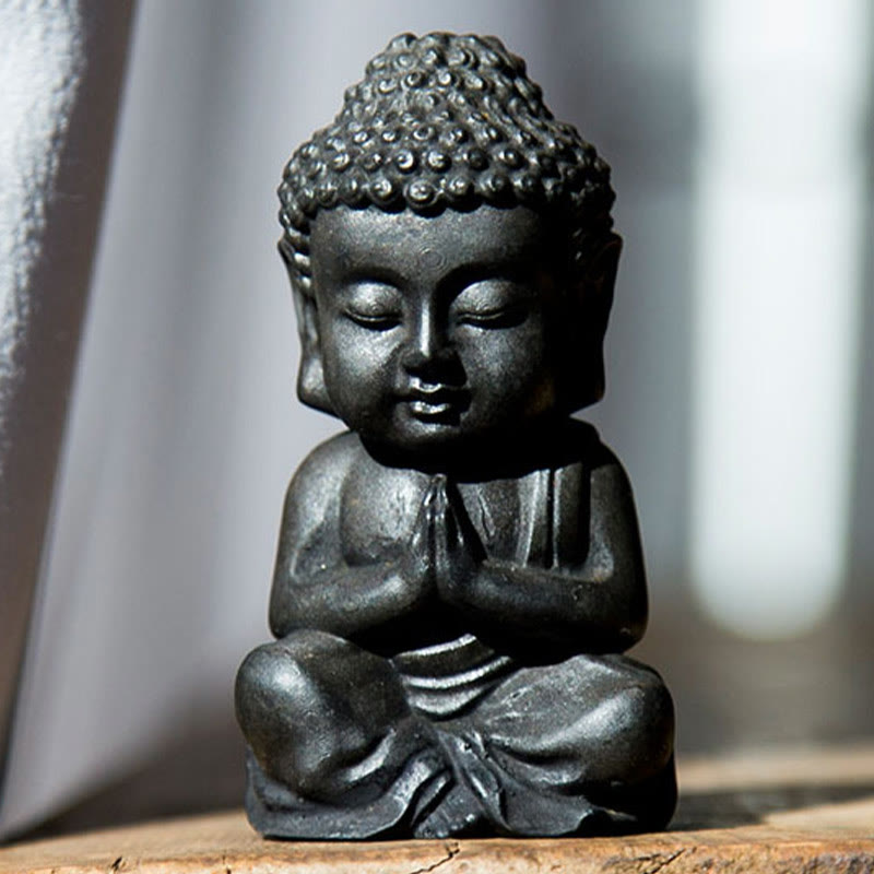 Small Sakyamuni Statue – in palm with coins for scale reference of pocket shrine size