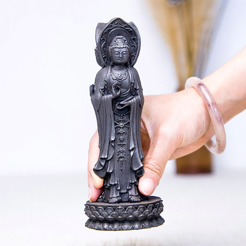 Three-Sided Kwan Yin Statue – flat lay on silk cloth showing base engraving and texture