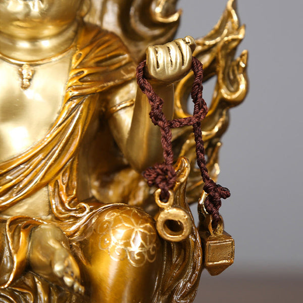 Acalanatha Buddha Statue – full figure on wooden surface with warm ambient altar lighting