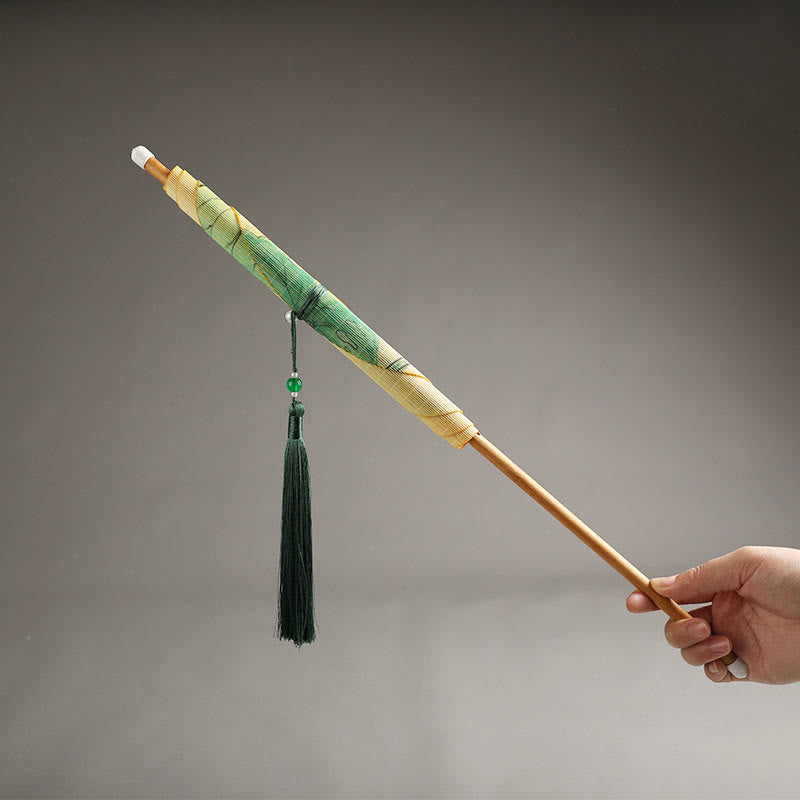 Chinese Koi Fish Lotus Fan - closed folding fan with green and gold landscape painting, bamboo handle and tassel