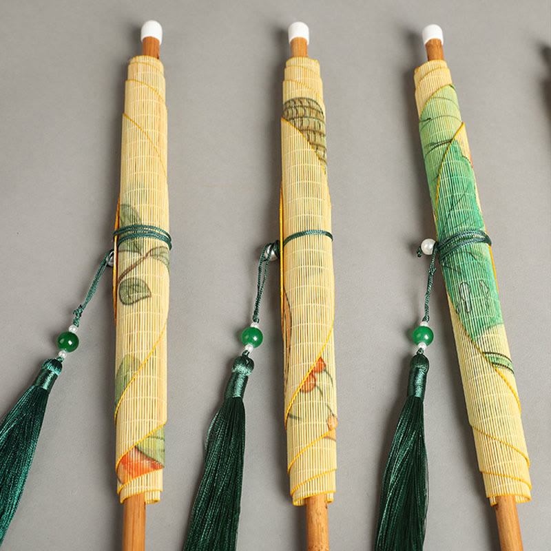 Chinese Koi Fish Lotus Fan - three rolled folding fans with botanical artwork, jade bead tassels, flat lay on gray