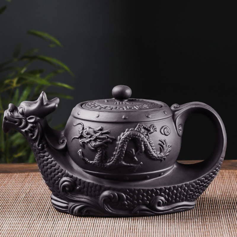 Vintage Dragon Auspicious Clouds Teapot – matte charcoal dragon teapot with scaled base on woven mat, serene bamboo setting