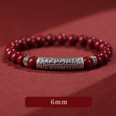 Cinnabar Sterling Silver Six True Words Bracelet – low angle view showing engraved silver center, 6mm cinnabar beads