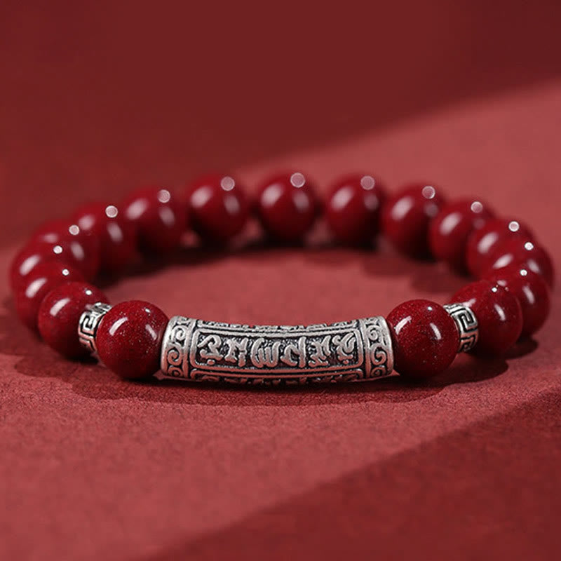Cinnabar Sterling Silver Six True Words Bracelet – hero shot on red, silver mantra barrel & red beads, blessing bracelet