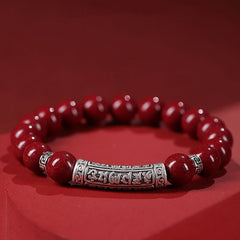 Cinnabar Sterling Silver Six True Words Bracelet – front view on red backdrop, silver mantra tube focal, zen jewelry