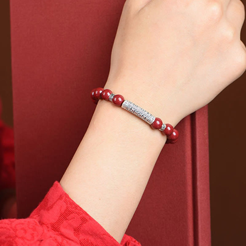 Cinnabar Sterling Silver Six True Words Bracelet – worn on wrist showing silver charm detail, red beaded bracelet