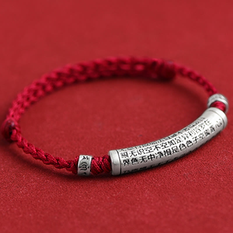999 Silver Heart Sutra Bracelet – Side angle of red braided cord with inscribed silver tube bead, Buddhist bracelet