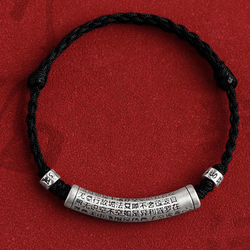 999 Silver Heart Sutra Bracelet – Black cord variant with silver Heart Sutra engraved cylinder on red background