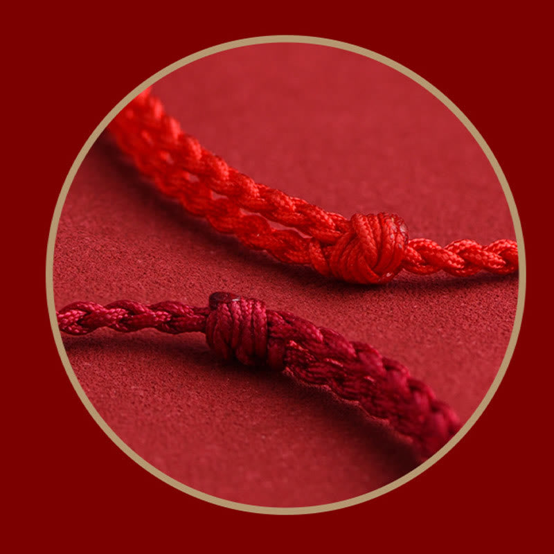 999 Silver Heart Sutra Bracelet – Circular close-up of two red braided cords with decorative knots, cord detail