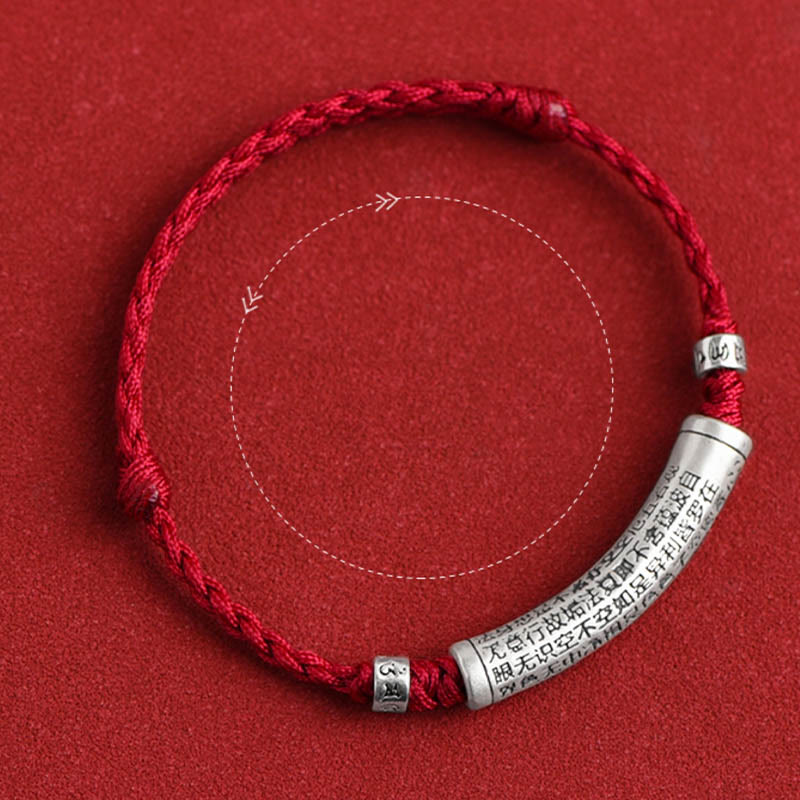 999 Silver Heart Sutra Bracelet – Overhead flat lay of red cord bracelet with scripture-engraved silver bead, lucky bracelet