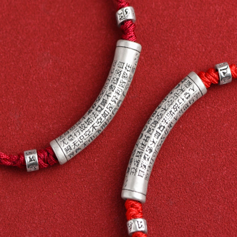 999 Silver Heart Sutra Bracelet – Macro close-up of two silver beads with dense Chinese scripture engraving on red cord