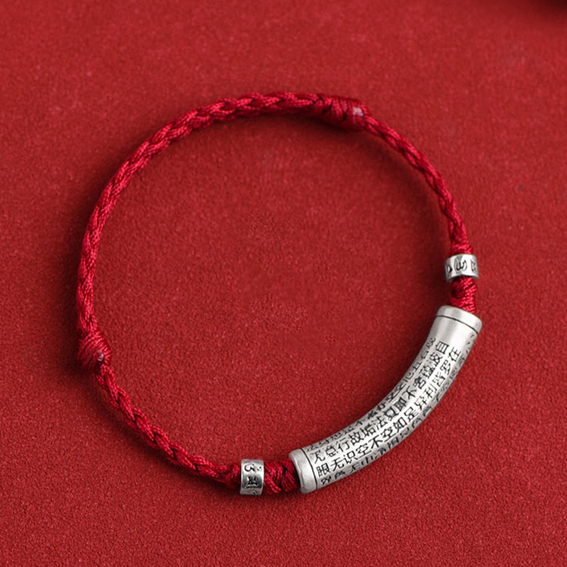 999 Silver Heart Sutra Bracelet – Top-down view of red cord with central silver mantra bead on red background, red string ...