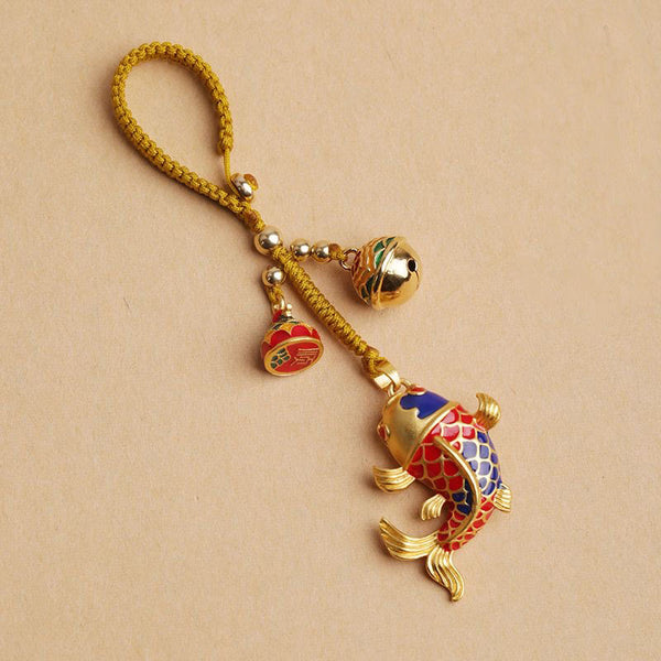 Colorful Koi Fish Hollow Bell Key Chain - blue and red enamel koi with gold braided cord and fortune bell on beige