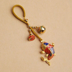 Colorful Koi Fish Hollow Bell Key Chain - blue and red enamel koi with gold braided cord and fortune bell on beige