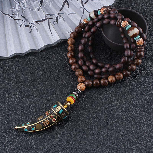 Wenge Wood Horn Pendant Necklace – Full length on dark surface with fan prop, mala necklace