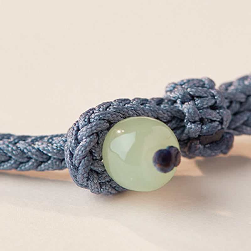 Jade Bead Knotting Detail – Macrame wrapped celadon bead on blue cord, jade bracelet