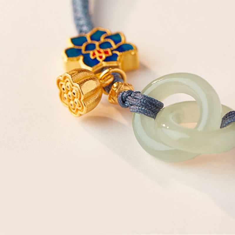 Interlocking Jade Rings Close-Up – Gold enamel charms on blue cord, jade bracelet
