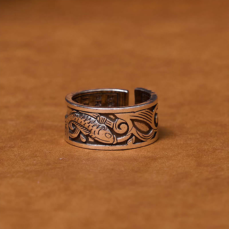 Koi Sutra Copper Ring – Close-up of Heart Sutra script engraving on warm copper surface, feng shui ring