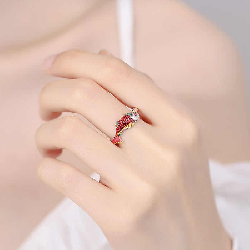 Koi Fish Wealth Prosperity Ring - koi fish wrap ring worn on hand, red and gold enamel scales, soft peach background