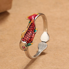 Koi Fish Wealth Prosperity Ring - close-up cloisonne koi with crimson scales, yellow and green fins on tan background