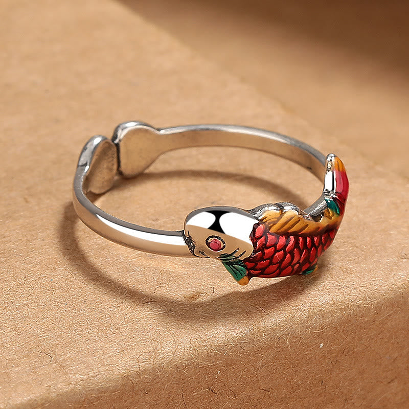 Koi Fish Wealth Prosperity Ring - three-quarter angle showing red enamel koi with green accents and gemstone eye detail
