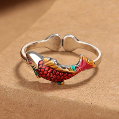 Koi Fish Wealth Prosperity Ring - silver adjustable band with red-orange enamel koi scales and golden fins on kraft paper