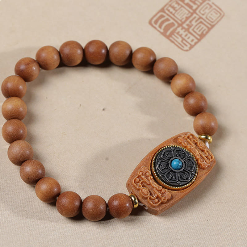 Sandalwood Six True Words Bracelet - Red sandalwood beads with turquoise mantra charm, flat lay