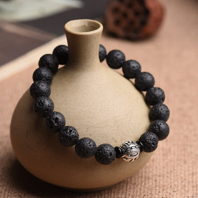Black Lava Stone PiXiu Bracelet on unglazed ceramic vase, woven textile, porous volcanic bead, feng shui wealth
