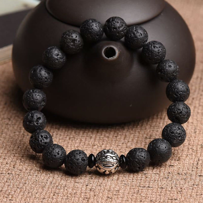 Black Lava Rock PiXiu Bracelet with dark teapot on burlap, volcanic bead, zen meditation accessory