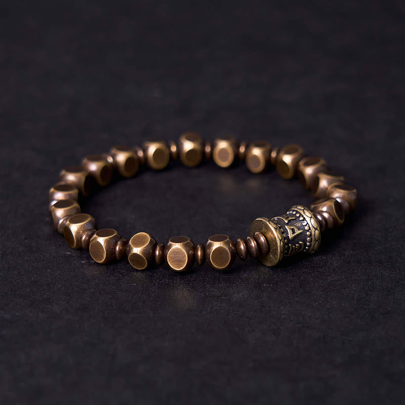 Brass Om Mani Padme Hum Bracelet – angled view showing carved focal bead with script and antique metal finish, Tibetan bracelet