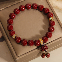 Cinnabar Lotus Charm Bracelet – Gold enamel spacers with carved lotus drop, red bead bracelet