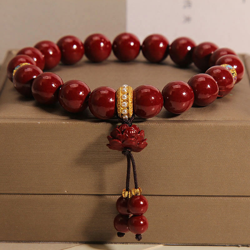 Cinnabar Lotus Blessing Charm Bracelet – Polished red beads with lotus pendant, charm bracelet