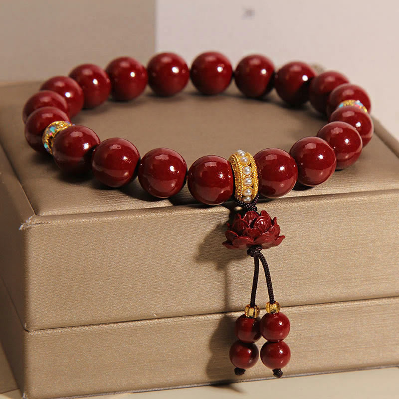 Cinnabar Blessing Bracelet – Carved lotus pendant with red bead strand on gold box, charm bracelet
