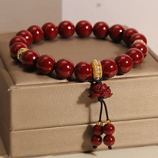 Cinnabar Blessing Bracelet – Carved lotus pendant with red bead strand on gold box, charm bracelet