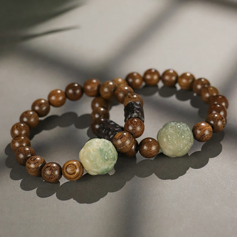Two Sandalwood Jade PiXiu Bracelets intertwined, carved guardian beast jade beads, dark spacers, zen lifestyle