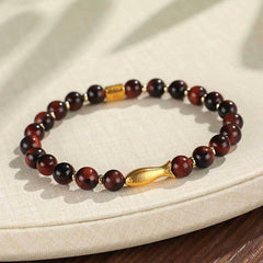 Tiger Eye Koi Fish Courage Bracelet – red tiger eye beads with gold fish charm on cream linen, three-quarter view