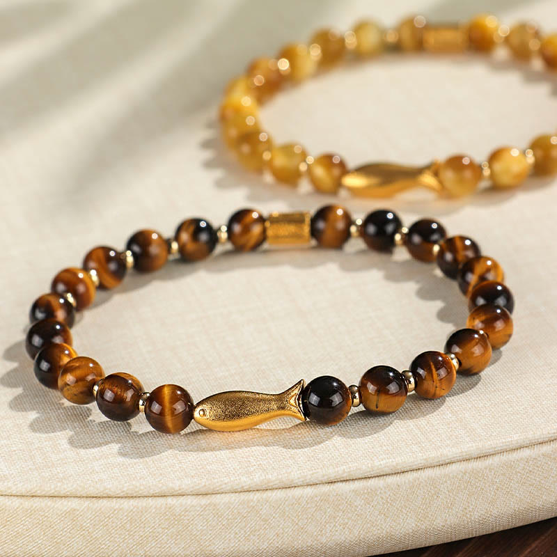 Tiger Eye Koi Fish Courage Bracelet – two tiger eye bracelets layered on linen, shallow depth of field, bokeh